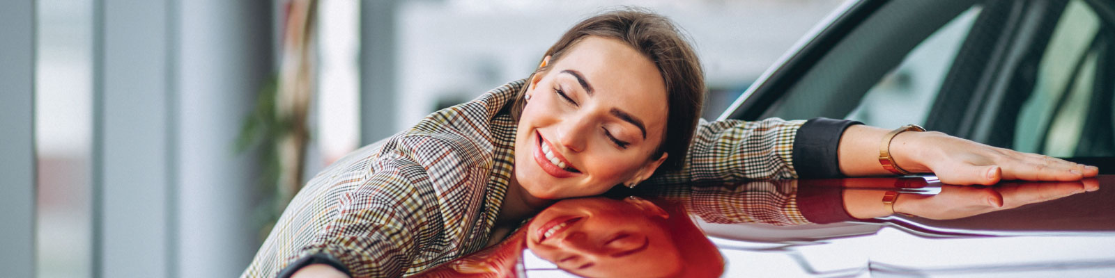 Person hugging a new car