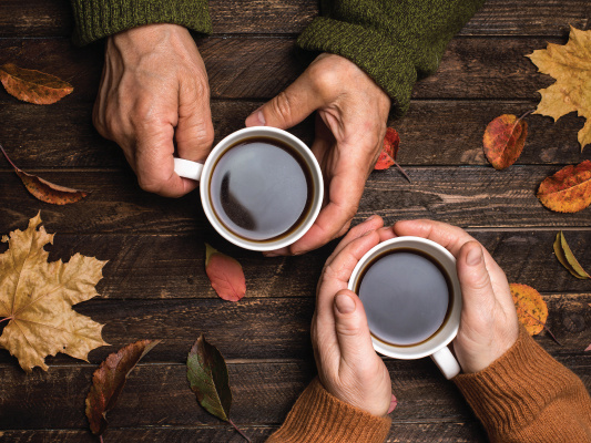 Older couple enjoying a hot drink in fall