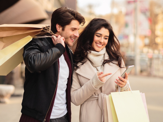 happy couple saving while shopping