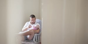 a dad feeding his baby