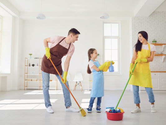 Happy family cleaning their home