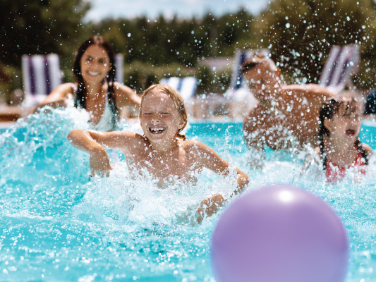 family having fun in pool