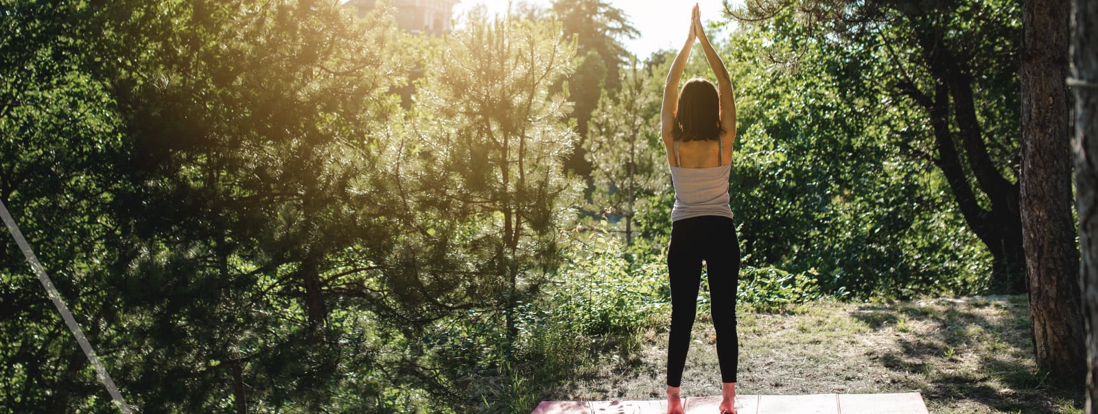 woman doing yoga in the woods