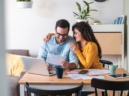 happy couple paying bills