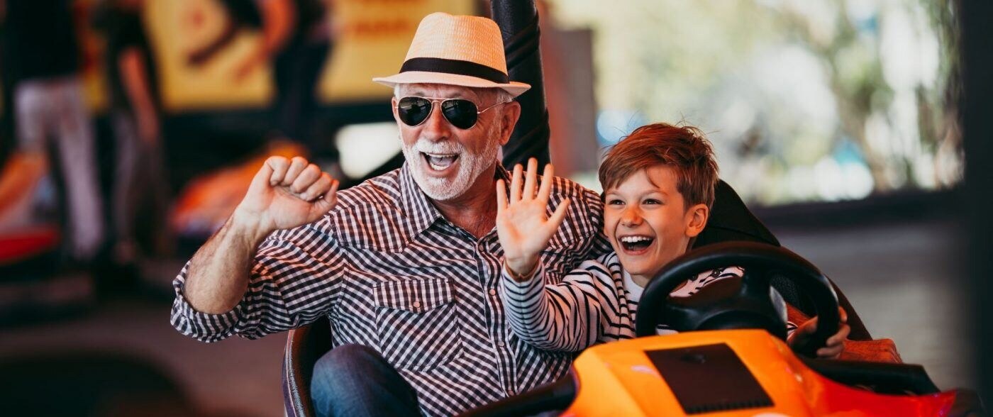 Grandfather and grandson in orange gocart