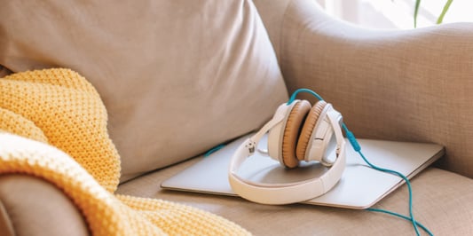 comfy chair with headphones and a laptop