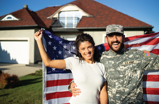 happy military couple holding flag