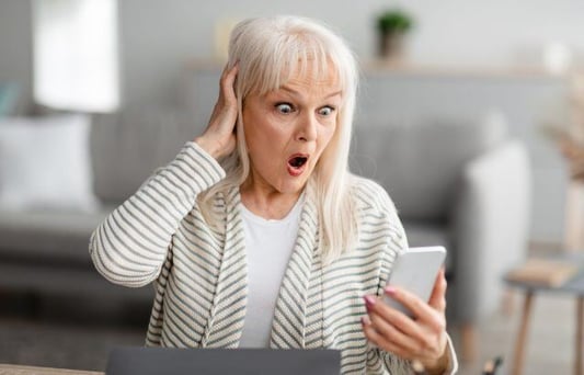 older person surprised by phone