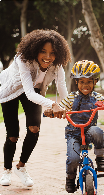 Parent and child learning to ride a bike is fun