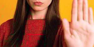 person-holding-hand-up-stop