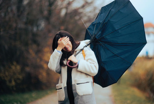 person-in-autumn-with-a-broken-umbrella