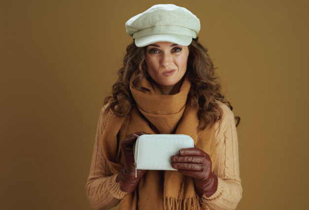 person-in-warm-clothes-looking-at-almost-empty-wallet