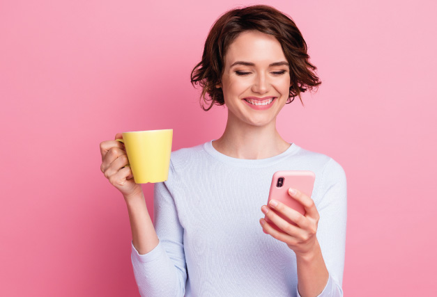 person-looking-at-phone-with-a-coffee-mug