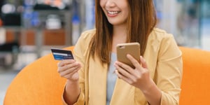 person_holding_credit_card_cell_phone
