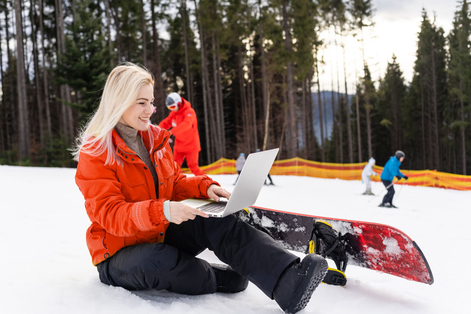 snowboarder-looking-at-laptop-online