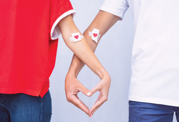 two-people-with-their-hands-shaping-a-heart