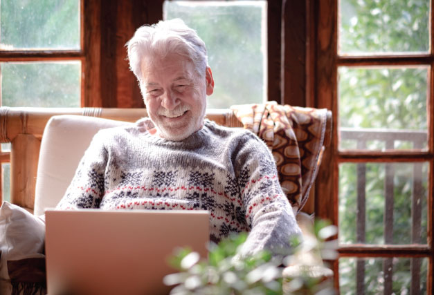 winter-older-person-enjoying-laptop-at-home