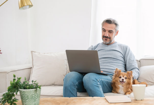 winter-pet-and-person-at-home-working-on-laptop