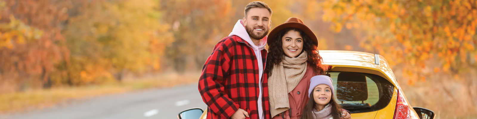 family enjoying an autumn drive in their new car