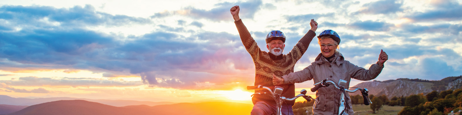 older-couple-mountain-biking-joyfully