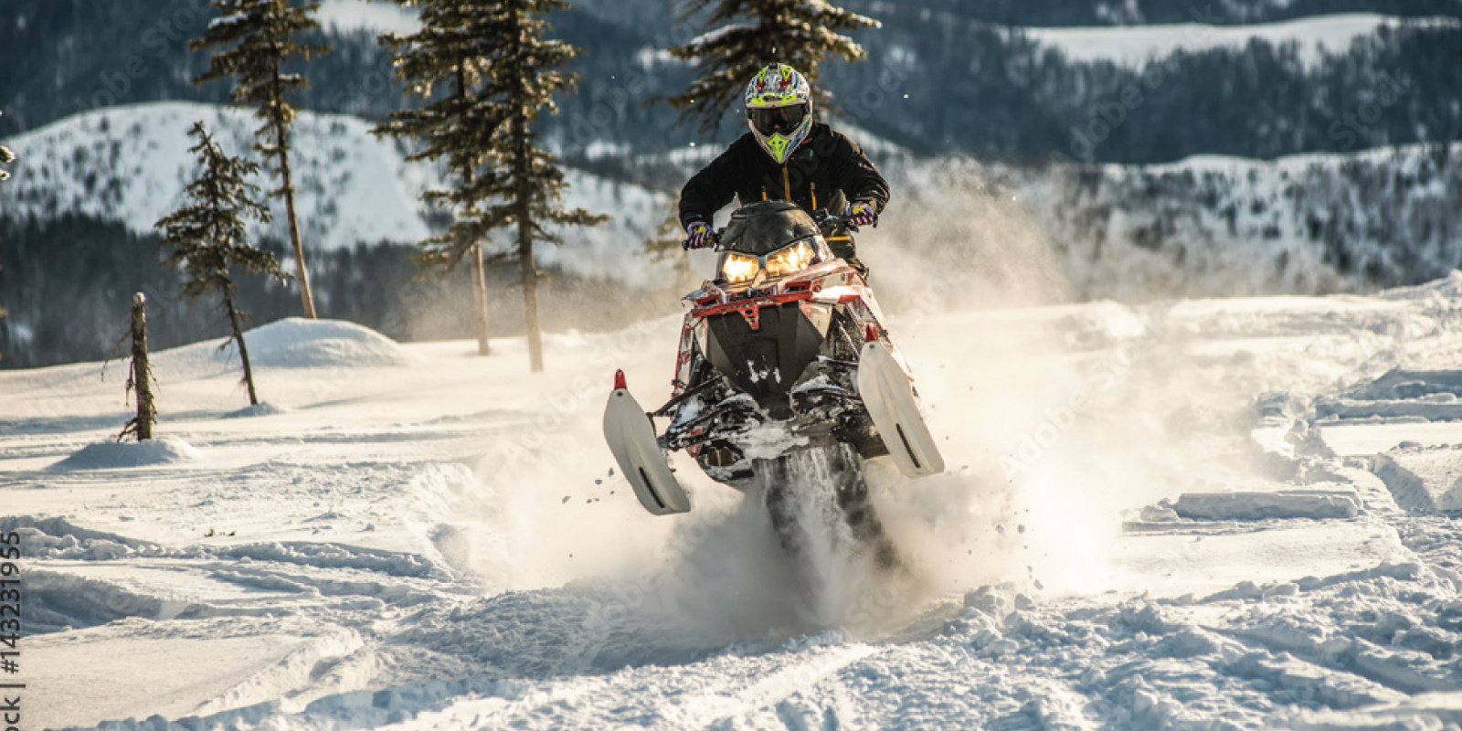 snowmobile flying through the snow