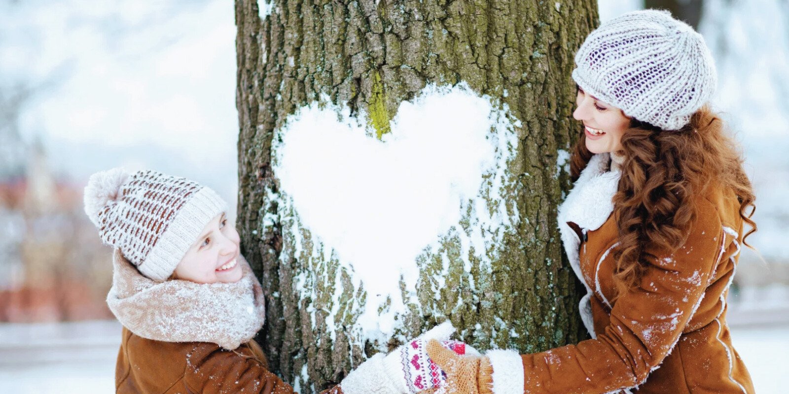 winter-family-hug-snow-heart-on-tree