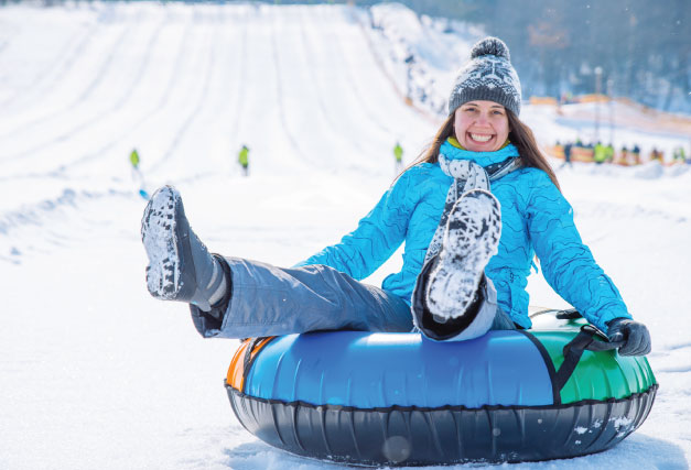winter-person-tubing-down-mountain