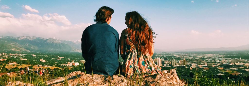 couple looking over city from a mountain