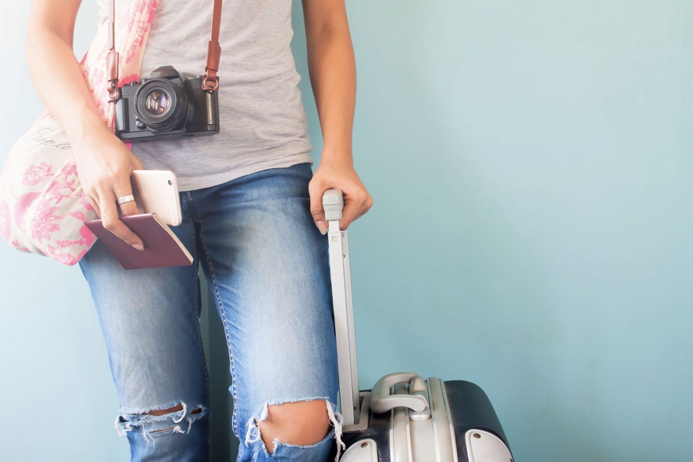woman with camera and luggage ready to explore the world