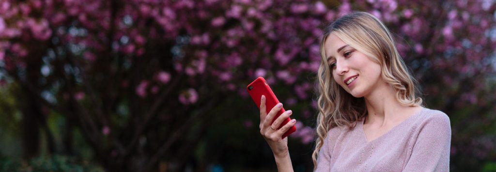 woman happy checking phone in spring