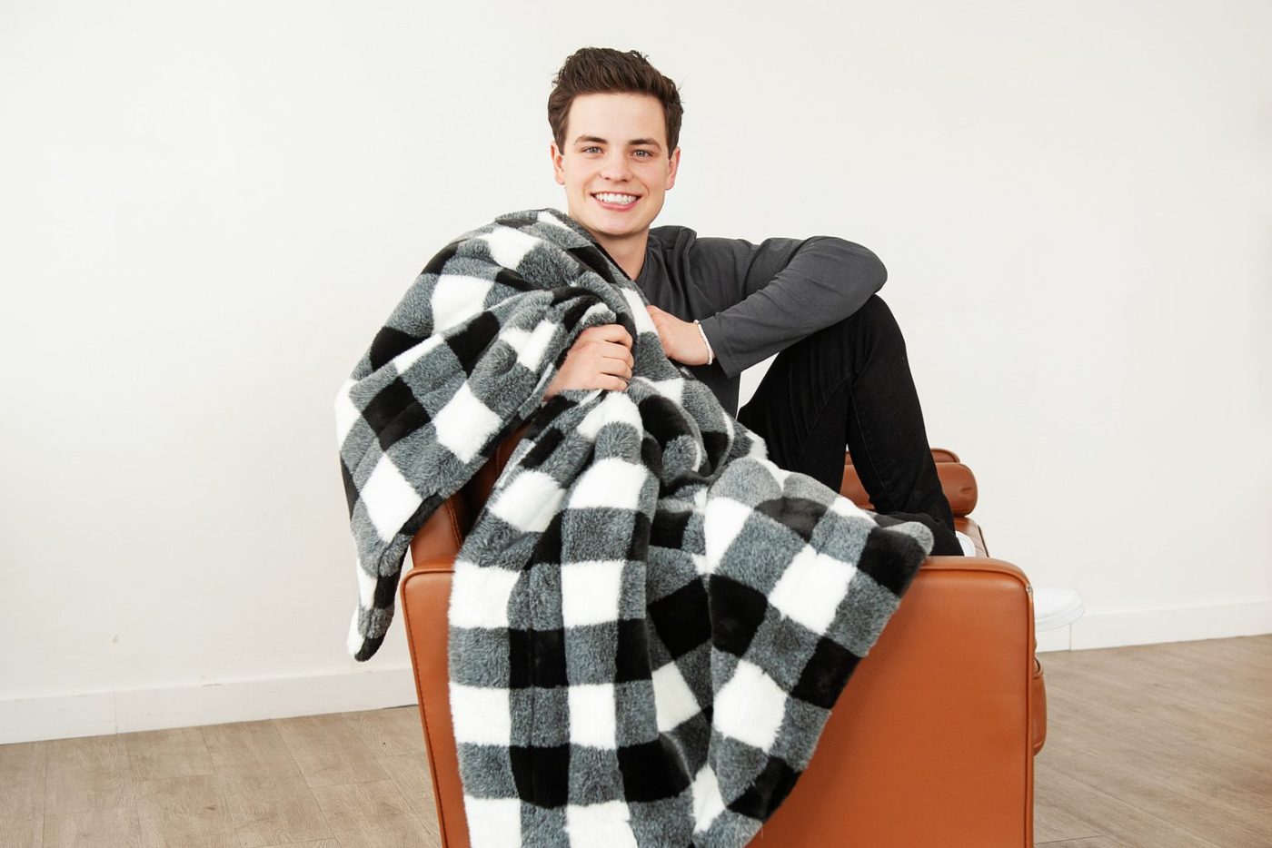 a teenage boy with a soft minky couture black and white checked blanket