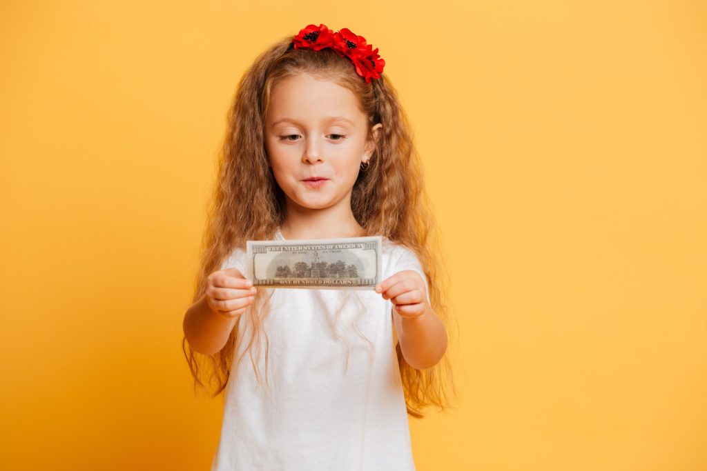 child holding money
