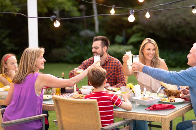 family having dinner outside summer