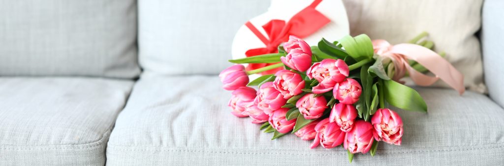 bouquet of pink tulips on couch