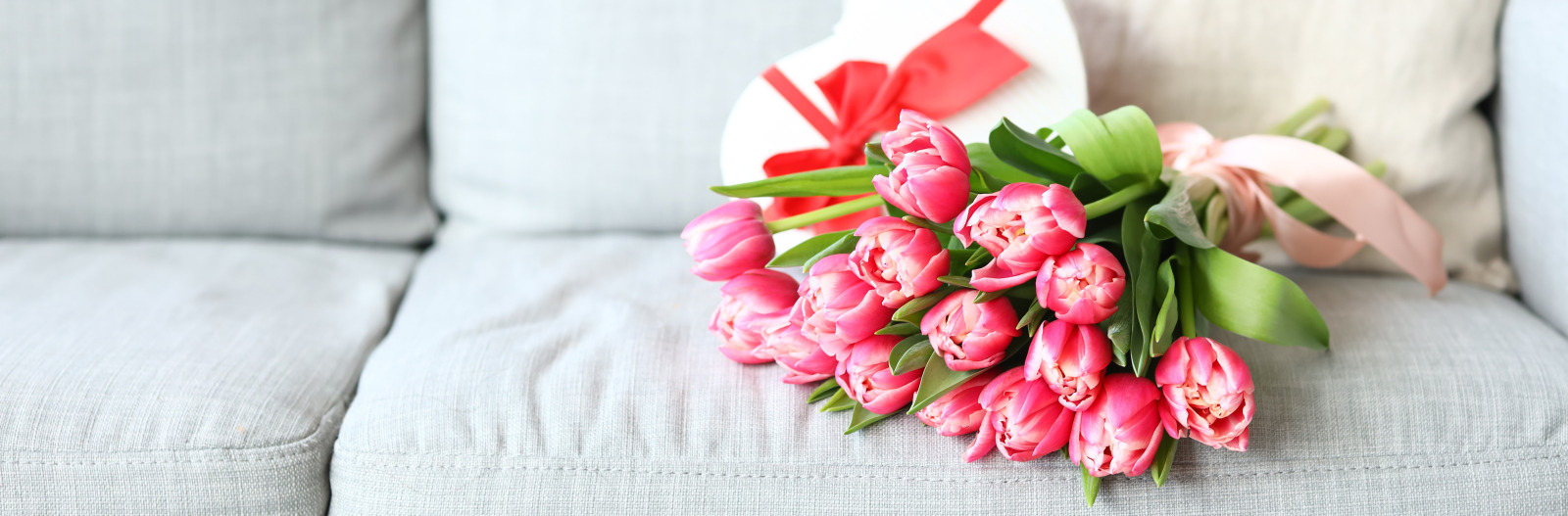 bouquet of pink tulips on couch