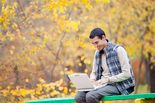 person on laptop in fall